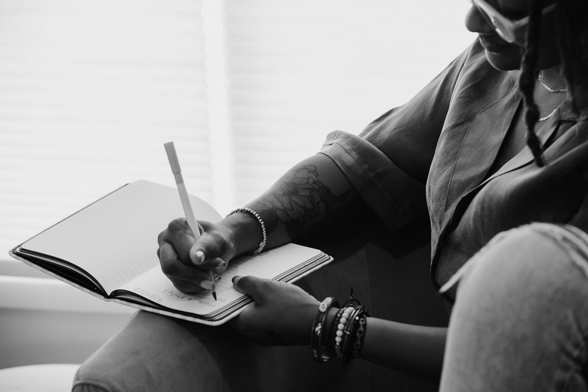 A person writing in a notebook during a study session