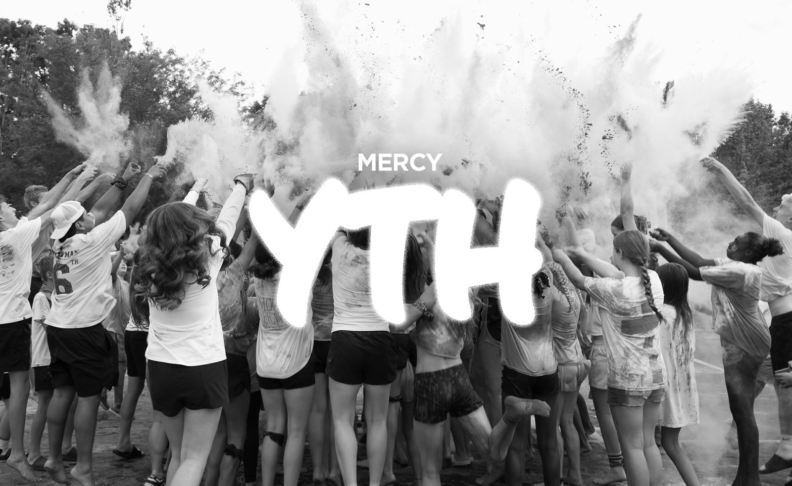 Mercy Youth logo over students celebrating with color powder
