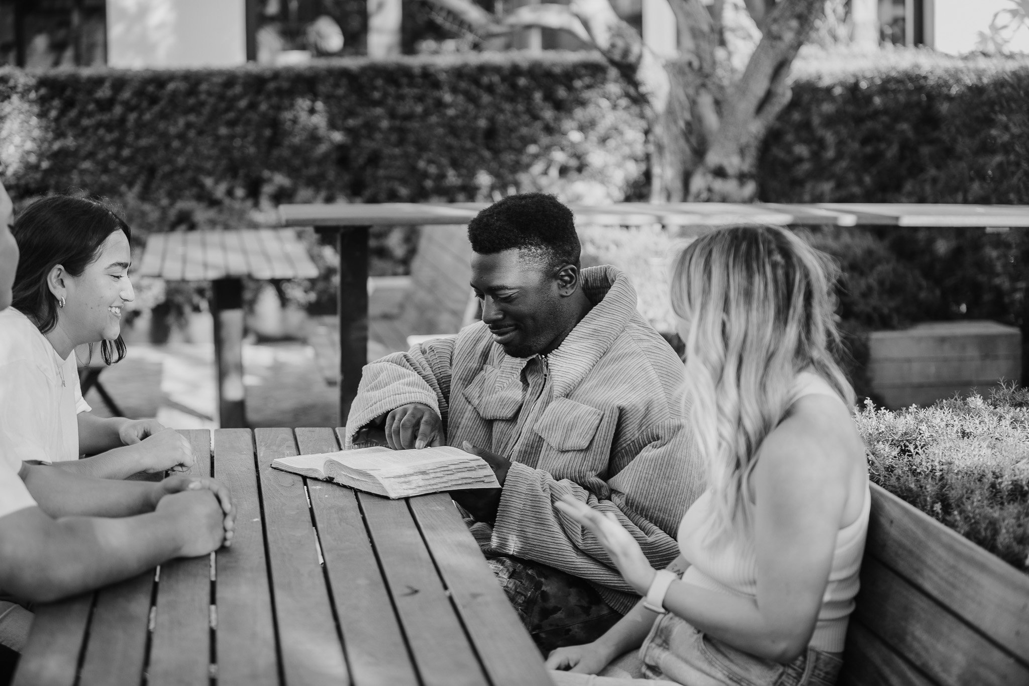 People studying the Bible together at an outdoor table
