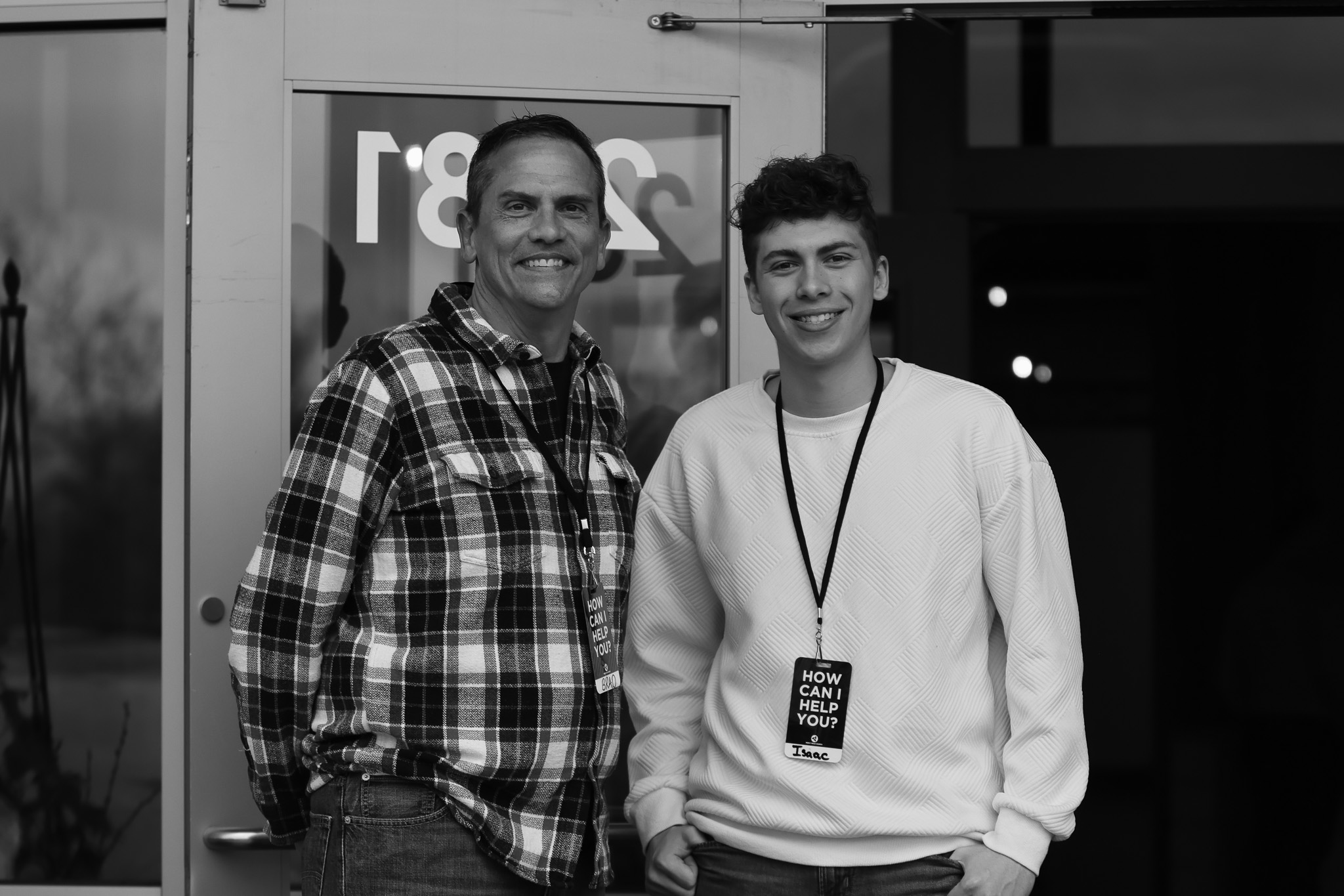 Two welcoming volunteers standing at the church entrance