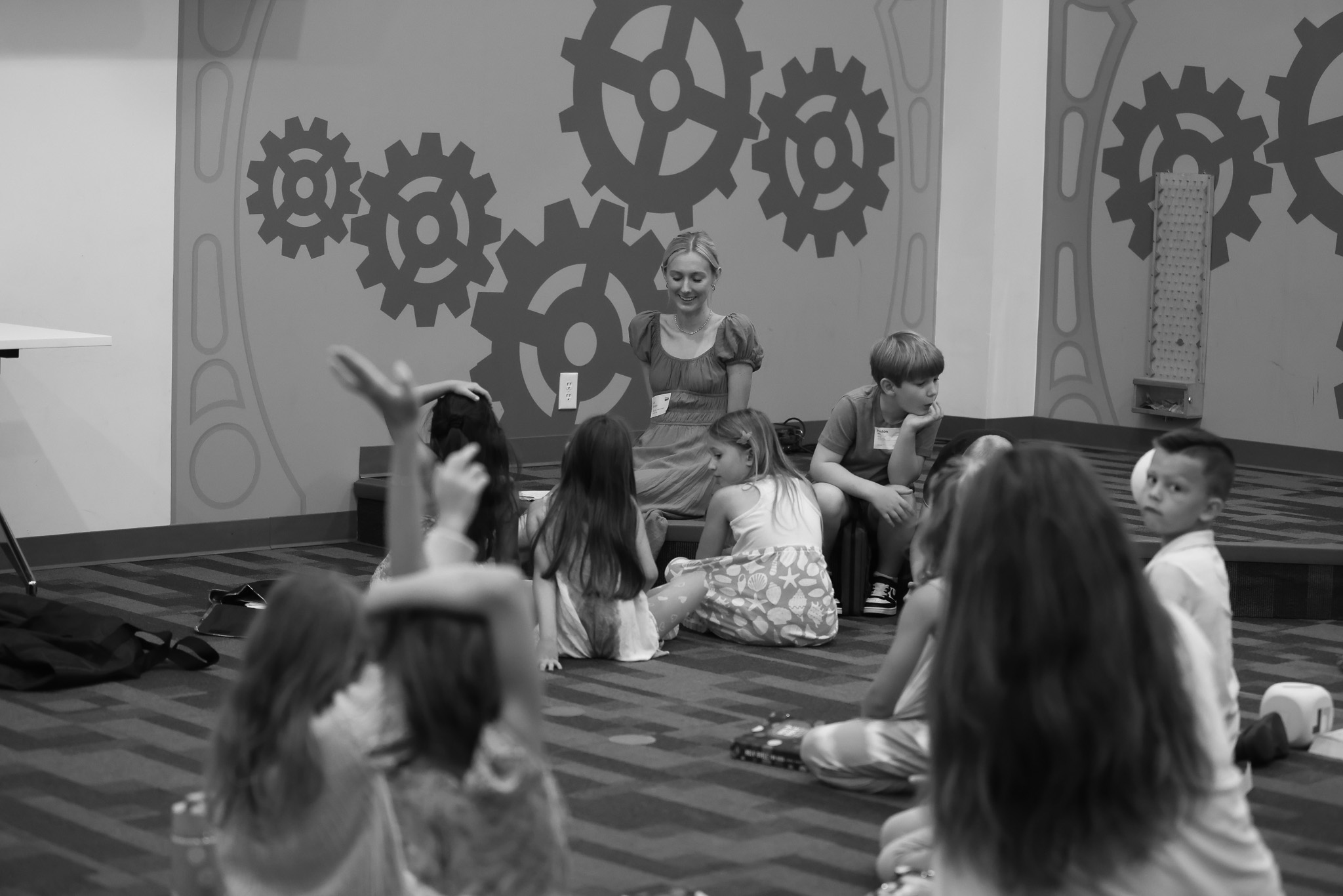 Mercy Kids volunteers sitting with children in a classroom
