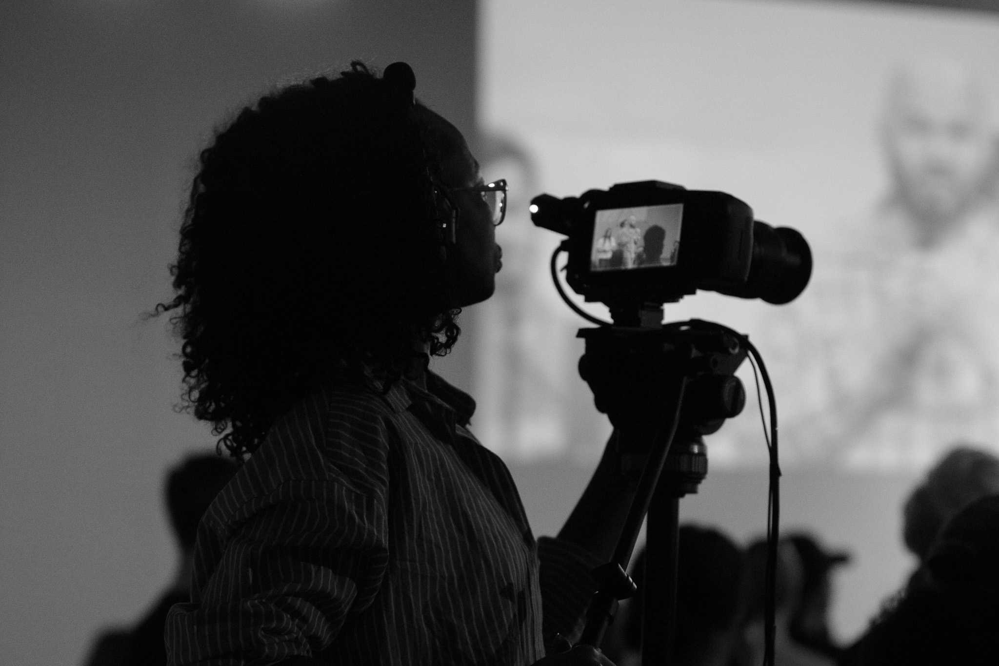 A production volunteer operating a video camera